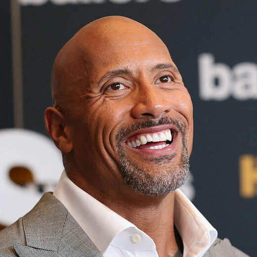 Actor Dwayne Johnson with a shaved head hairstyle.