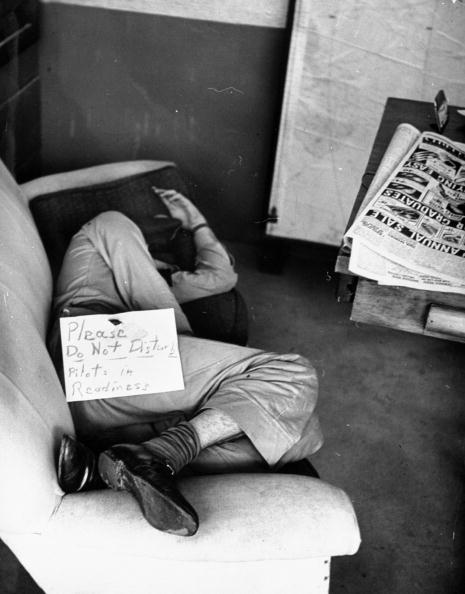 Vintage man napping on couch do not disturb sign.