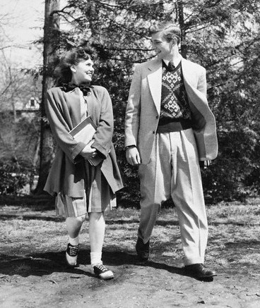 Vintage young man and woman walking outdoors talking smiling.